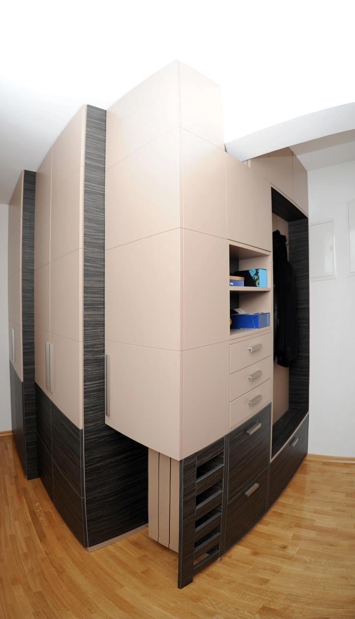 Modern corner wardrobe with cream and black two-tone finish, featuring shelving, drawers, and open compartments in a bedroom